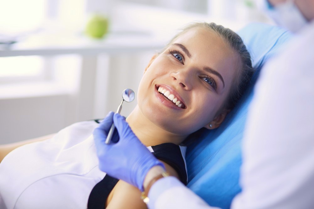 girl smiling in dentist chair, dental crowns Pearland, TX